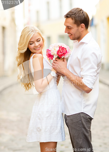 Image of couple with flowers in the city