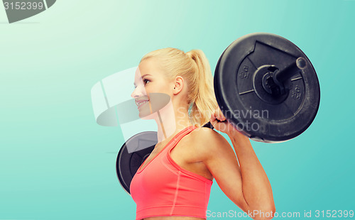 Image of smiling sporty woman exercising with barbell