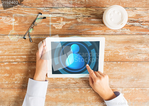 Image of close up of hands with user icon on tablet pc