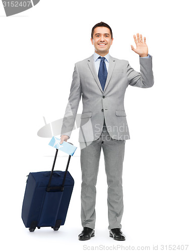 Image of happy businessman in suit with travel bag