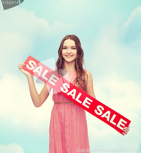 Image of young woman in dress with sale sign
