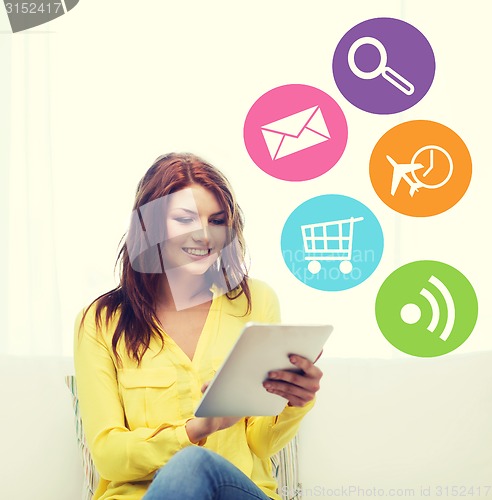 Image of smiling woman with tablet pc computer at home