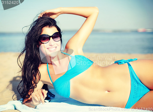 Image of girl sunbathing on the beach