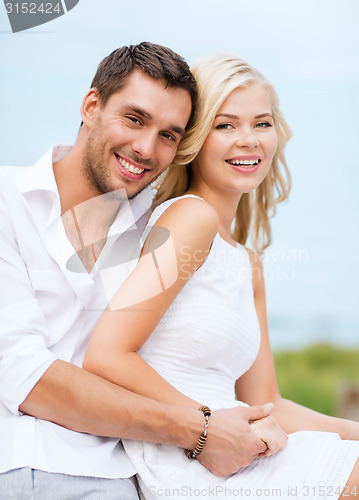 Image of couple in shades at sea side