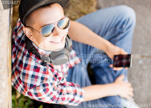 Image of girl with headphones and smartphone