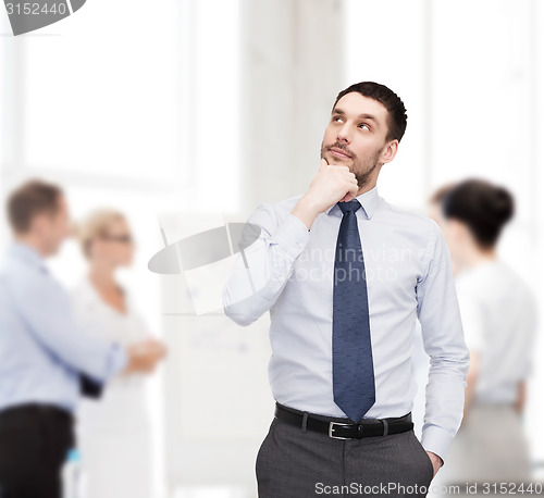 Image of handsome businessman looking up