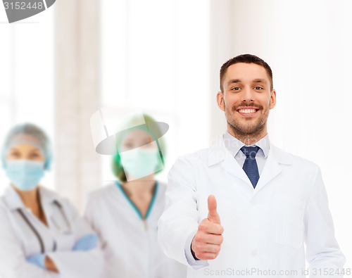 Image of smiling male doctor showing thumbs up