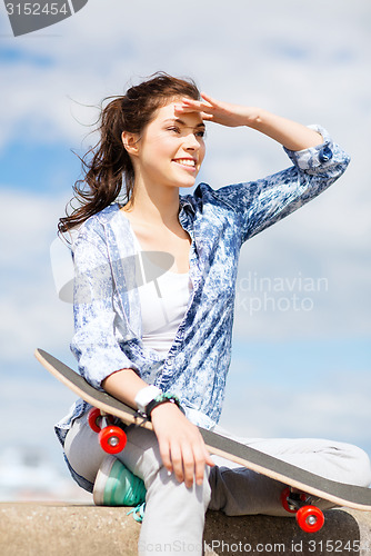 Image of teenage girl with skate outside