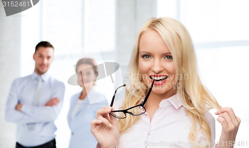 Image of smiling businesswoman or secretary in office