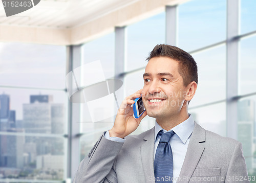 Image of happy businessman calling on smartphone