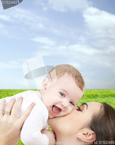 Image of laughing baby playing with mother