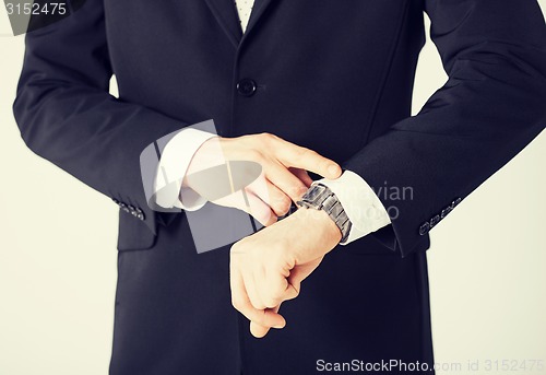 Image of man looking at wristwatch