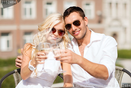 Image of couple drinking wine in cafe