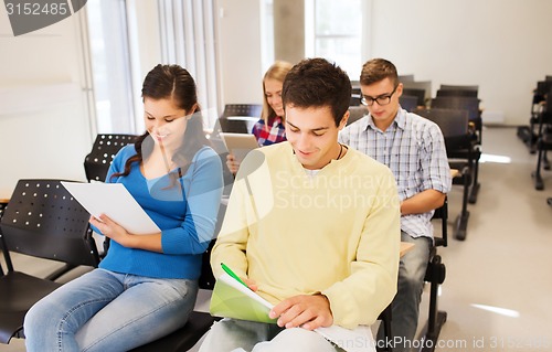 Image of group of smiling students in lecture hall