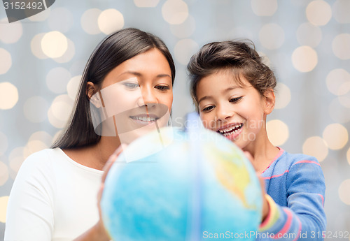 Image of mother and daughter with globe