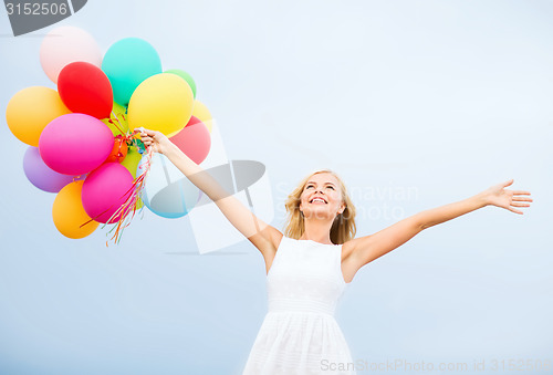 Image of woman with colorful balloons outside