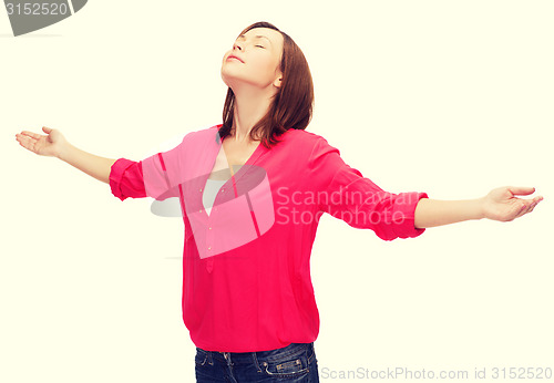 Image of smiling woman waving hands with closed eyes