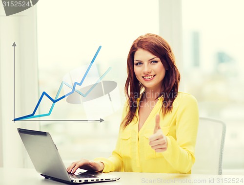 Image of smiling student with laptop computer at school