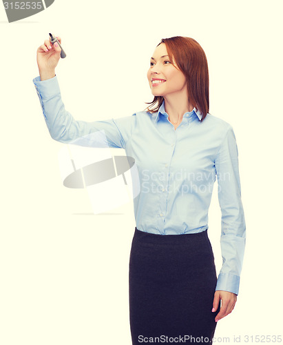 Image of businesswoman writing something in air with marker