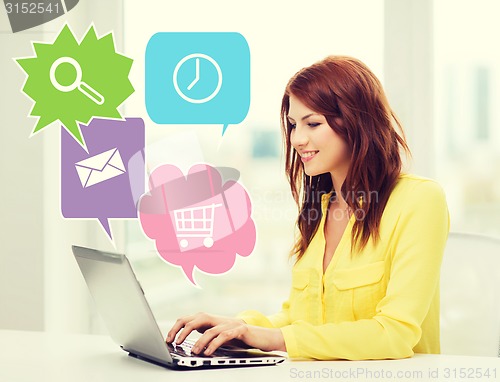 Image of smiling woman with laptop computer at home