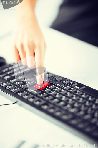 Image of hand pressing success button on keyboard