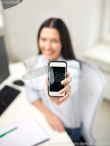 Image of close up of woman showing smartphone at office