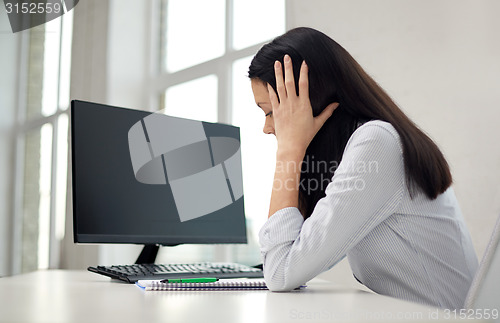 Image of close up of sad woman with computer and notebook