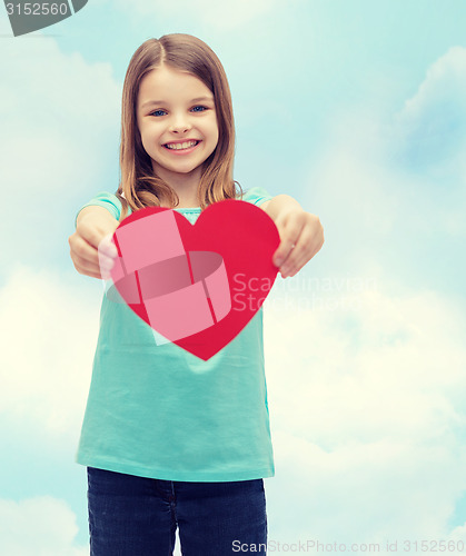 Image of smiling little girl giving red heart