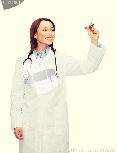 Image of young female doctor writing something in the air