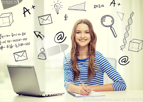 Image of smiling teenage girl laptop computer and notebook