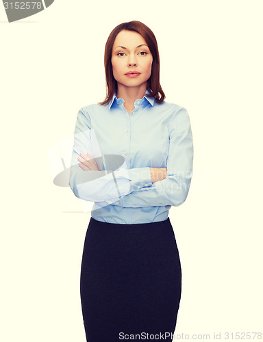 Image of smiling businesswoman with crossed arms