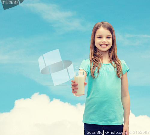 Image of smiling little girl giving glass of milk