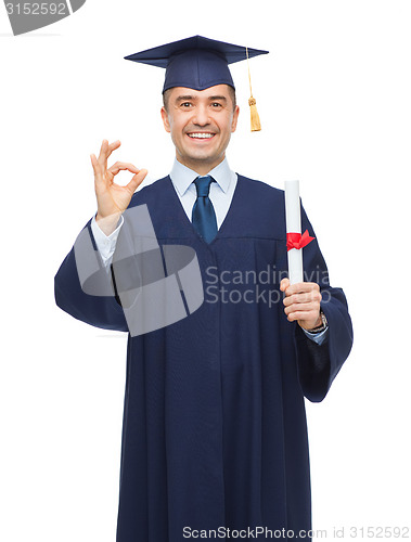 Image of smiling adult student in mortarboard with diploma