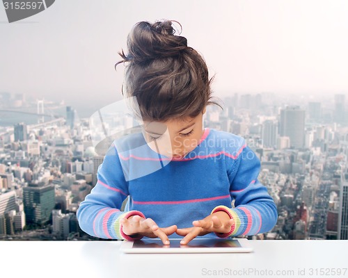 Image of little girl with tablet pc over city background