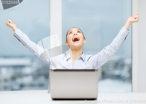 Image of screaming businesswoman with laptop in office