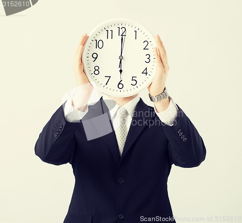 Image of man with wall clock