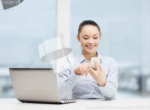 Image of smiling businesswoman with laptop