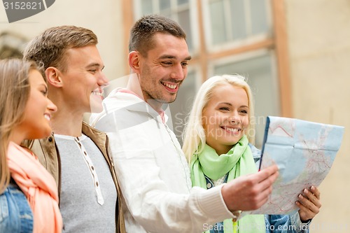Image of group of friends with map exploring city