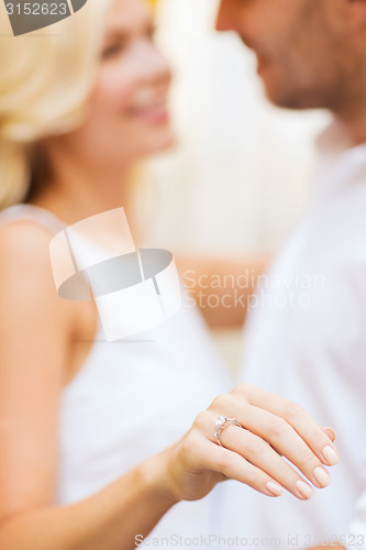 Image of romantic man proposing to beautiful woman