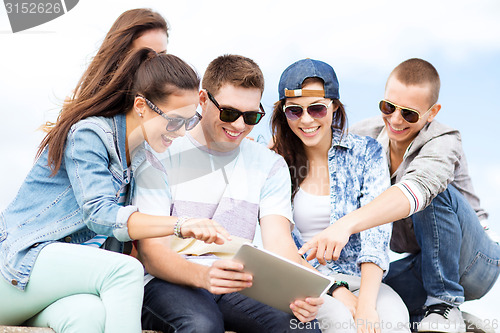 Image of group of teenagers looking at tablet pc