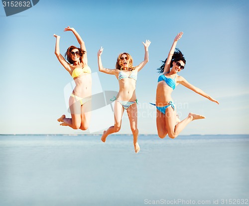 Image of girls jumping on the beach