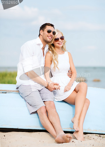 Image of couple in shades at sea side