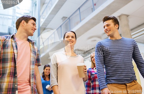 Image of group of smiling students with paper coffee cups