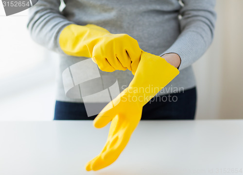 Image of close up of woman wearing protective rubber gloves