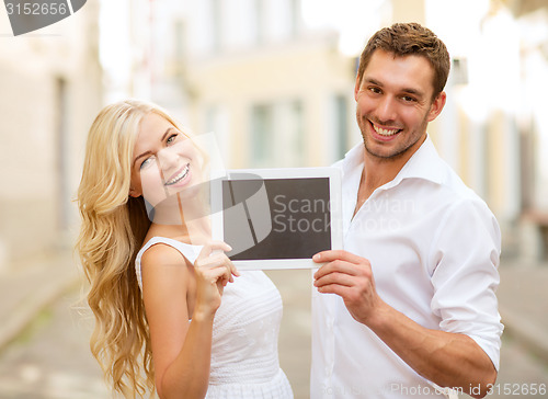 Image of couple with tablet pc in the city