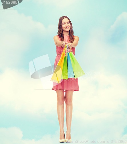 Image of smiling woman in dress with many shopping bags