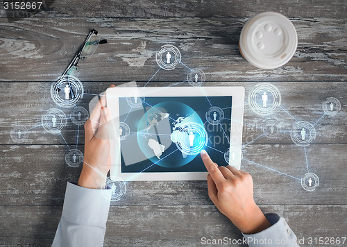 Image of close up of hands with tablet pc and network