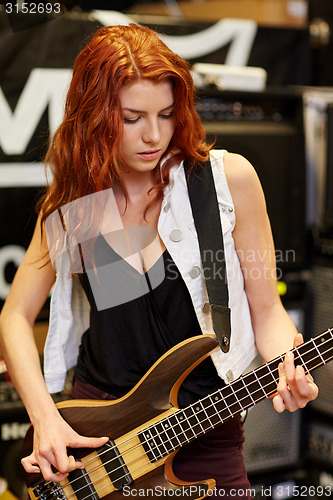 Image of musician or customer with guitar at music store