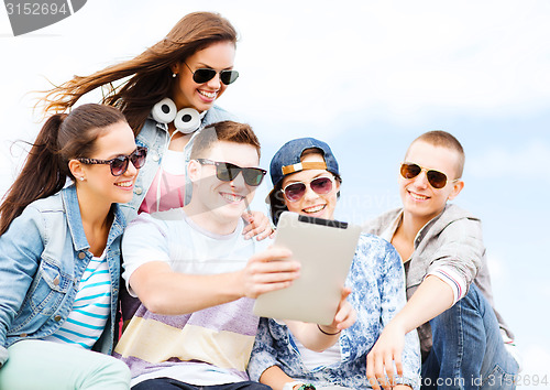 Image of group of teenagers looking at tablet pc