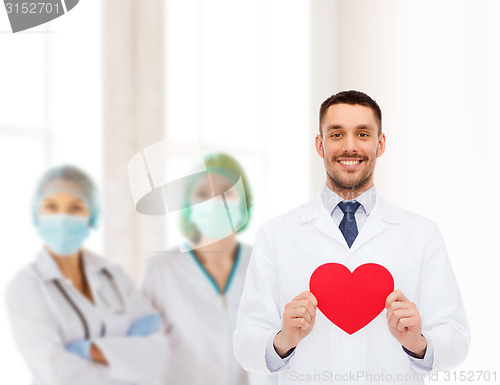 Image of smiling male doctor with red heart
